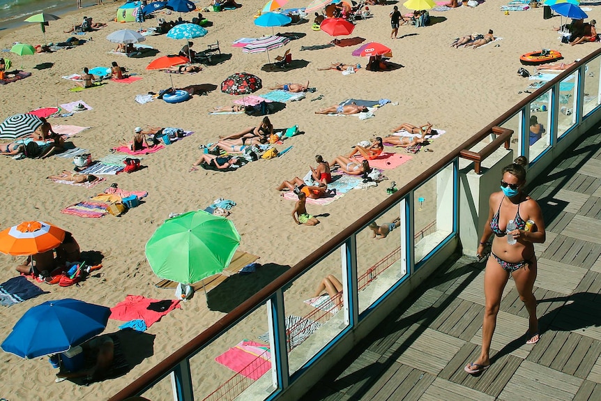 Bikini woman wearing face mask at France beach