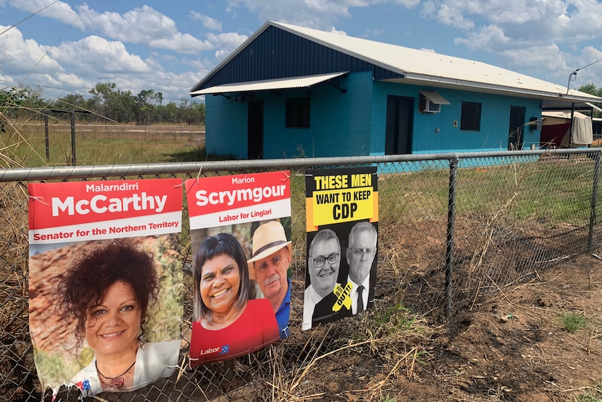 Election signage is seen on a fence outside a remote house.