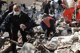 Rescue workers carry body recovered from Italian quake