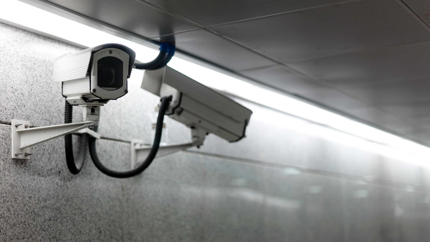 Two video cameras mounted on a wall
