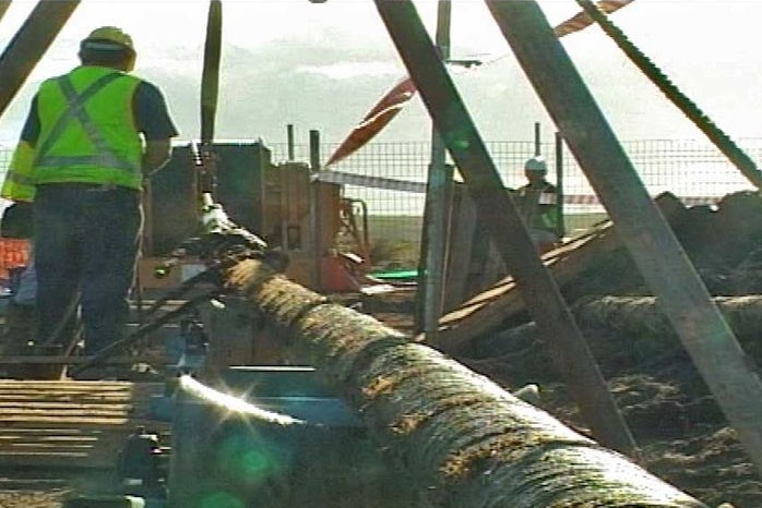 A worker helps lay a cable for the Basslink power project in 2006