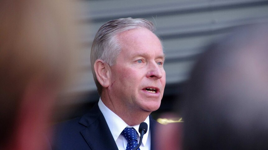 Close up shot of WA Premier Colin Barnett, with blurred journalists in foreground. November 20, 2015.