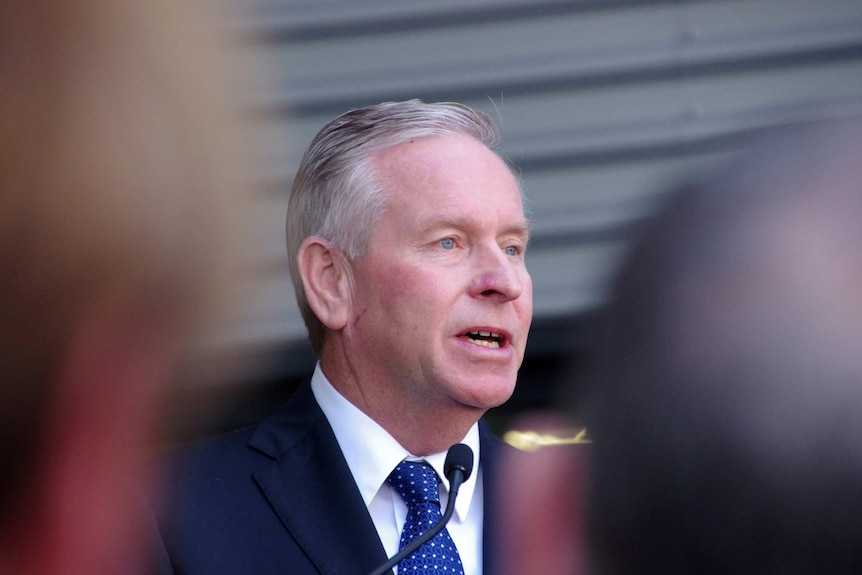 Close up shot of WA Premier Colin Barnett, with blurred journalists in foreground. November 20, 2015.