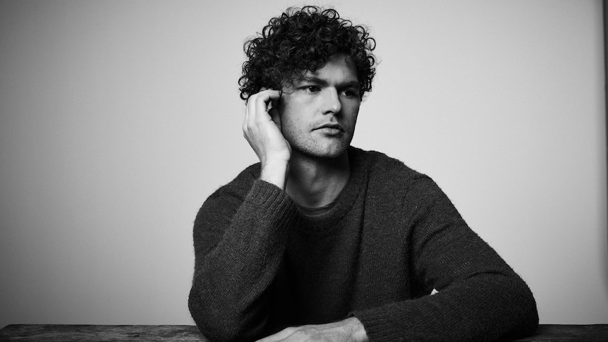 A 2018 press shot of Vance Joy staring pensively off into the distance