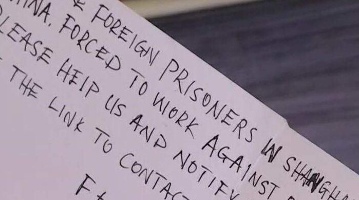 A hand-written message which says foreign prisoners are being forced to work against their will in a Chinese prison.