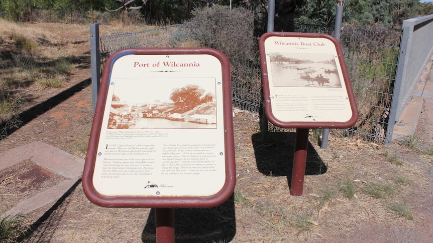 Two signs in Wilcannia, one displaying the Port of Wilcannia, the other about Wilcannia's boat club