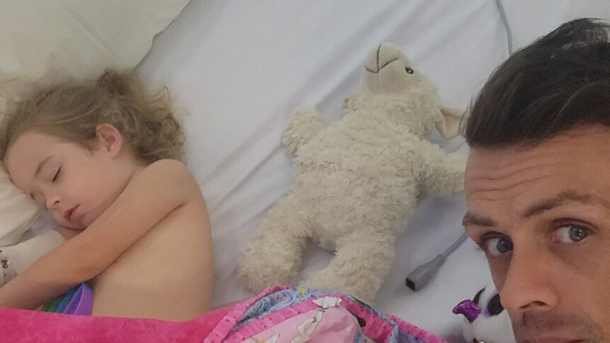 Navaeh Austin asleep in hospital with her dad.