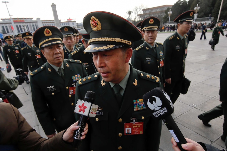 Representatives from China's People's Liberation Army heading into Beijing's Great Hall of the People.
