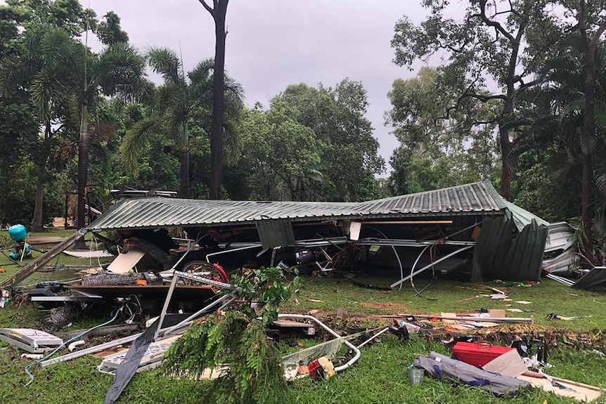 Flattened shed with debris surrounding it.