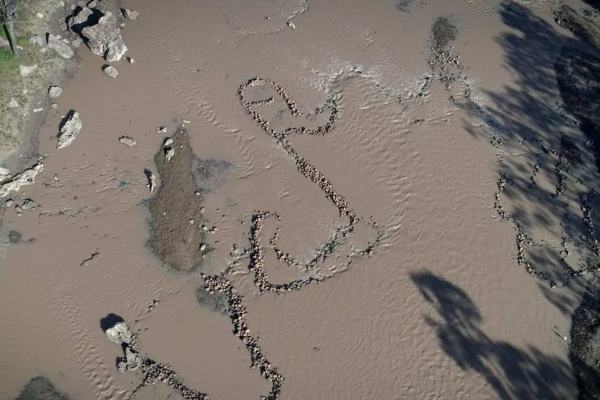 An aerial shot of rock formations in a waterway.