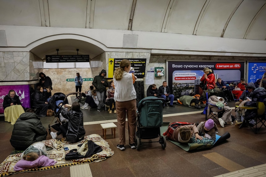 People sheltering inside an underground train station.