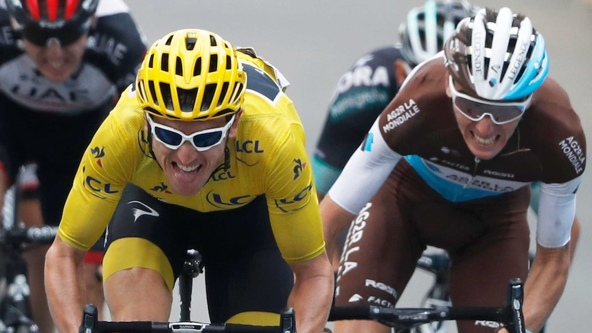 Geraint Thomas, in yellow, grits his teeth to sprint away from a similarly grimacing Romain Bardet