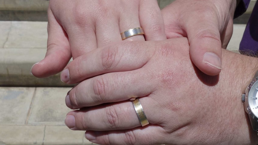 Same-sex couple show off their wedding rings