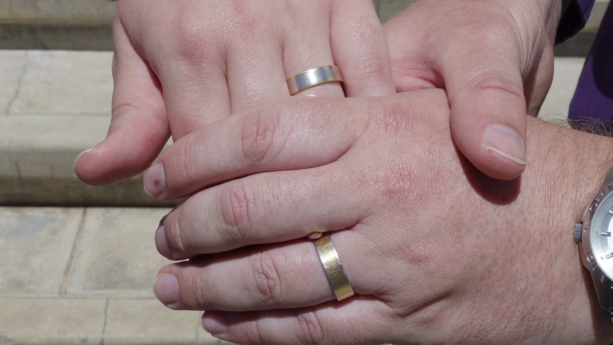 Ulises Garcia and Craig Berry show off their rings after being married in Canberra under the ACT's Marriage Equality Bill.