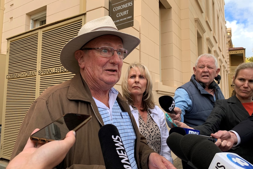 A man addresses the media.