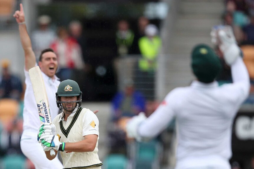 South Africa's Kyle Abbott (L) and Quinton de Kock (R), celebrate wicket of Australia's Joe Burns.