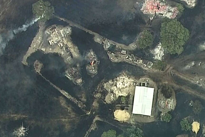 Aerial photo of a blackened land within the town of Lucindale, as a fire sweeps through.