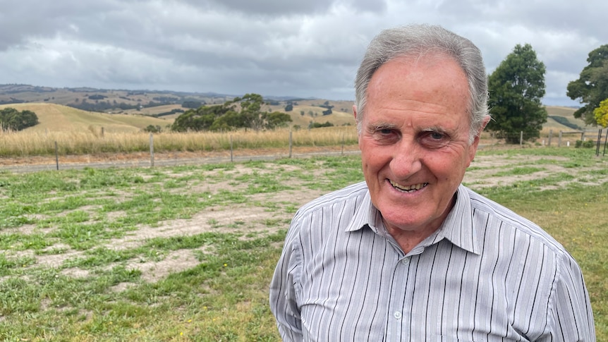 Man stands in fron of pastoral landscape