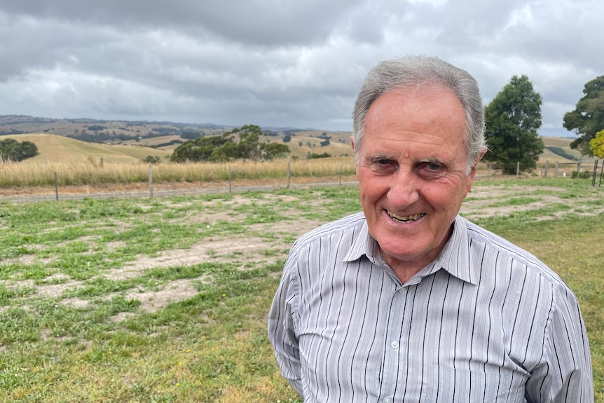 Man stands in fron of pastoral landscape