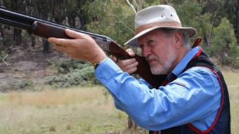 Robert Borsak MLC holding a gun as he prepares to take part in a Clay Target Game Club