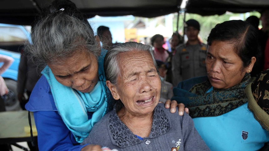 Relatives of victims of a sunken ferry weep