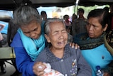 Relatives of victims of a sunken ferry weep