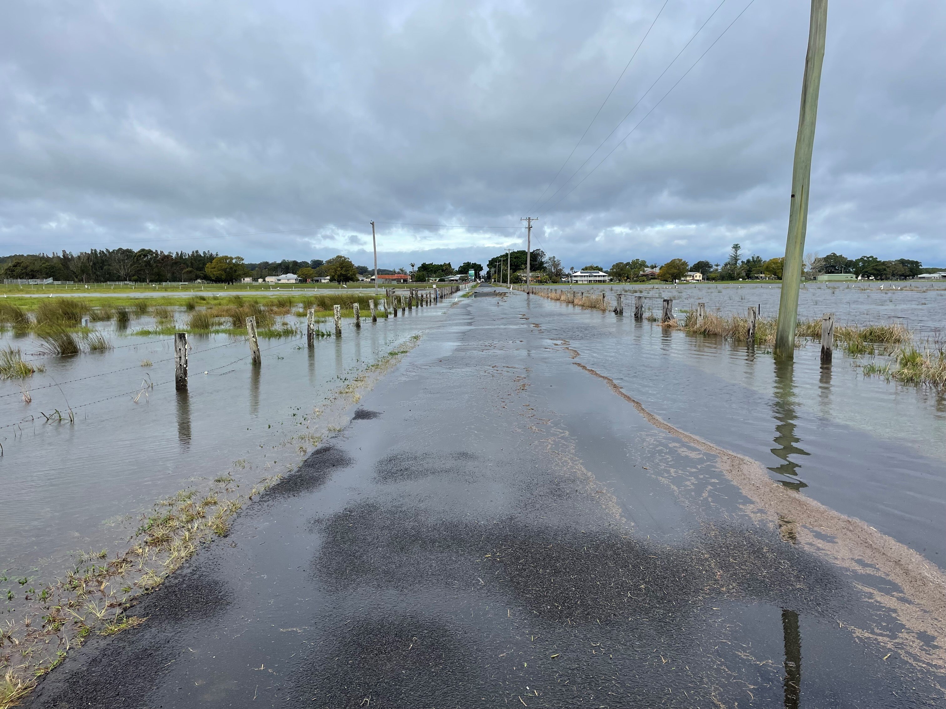 Water over a road and pooled on either side