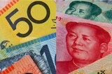 LtoR Australian dollar notes and Chinese Yuan.