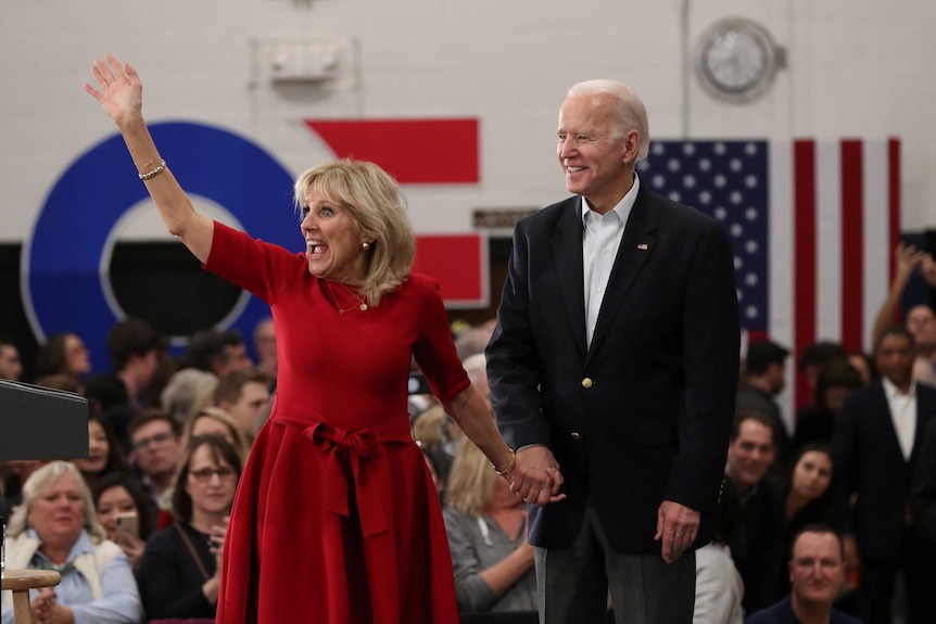 Joe biden and his wife Jill on a stage in Iowa