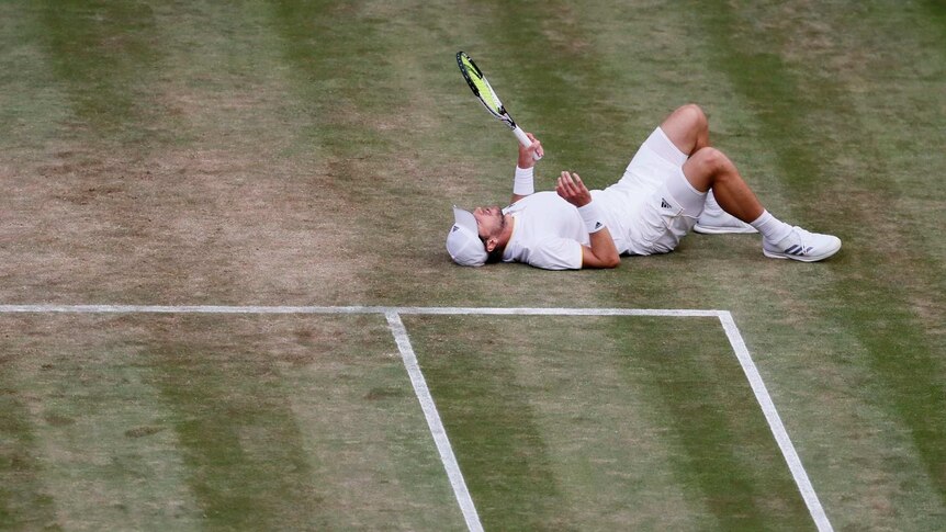 Mischa Zverev takes a tumble against Roger Federer at Wimbledon