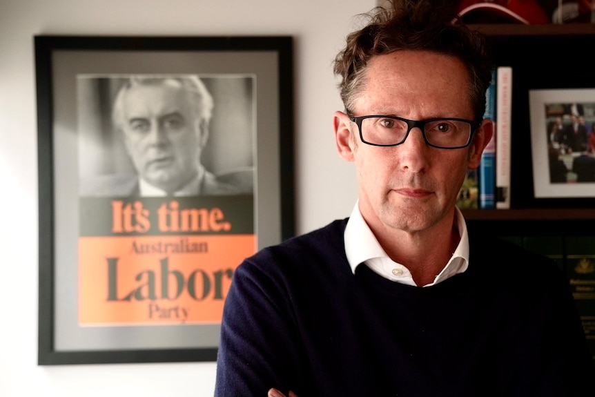 Stephen Jones stands in front of a Gough Whitlam Labor party poster