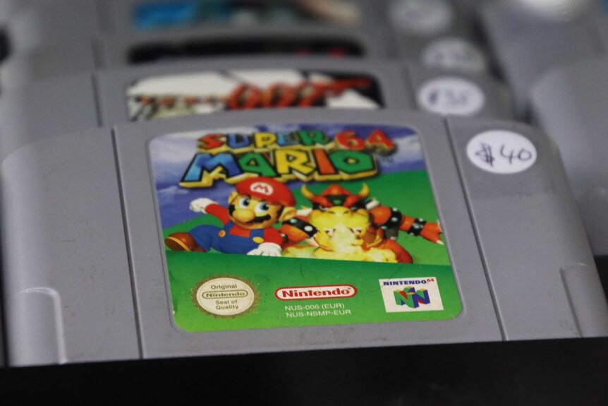 A collection of Nintendo 64 game cartridges including Super Mario 64 and Goldeneye