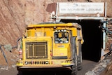 A yellow mining truck at the opening of a mine in the Goldfields