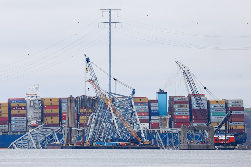 Wreckage of the Francis Scott Key bridge lies across the deck of the Dali cargo vessel as salvage work continue