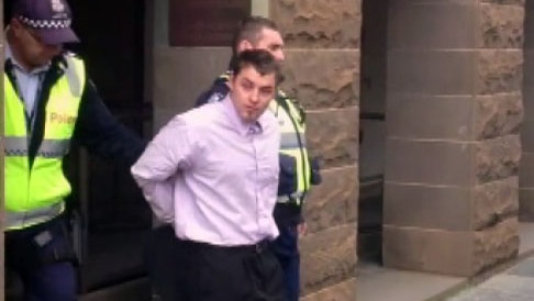 Harley Hicks being taken out of court by police