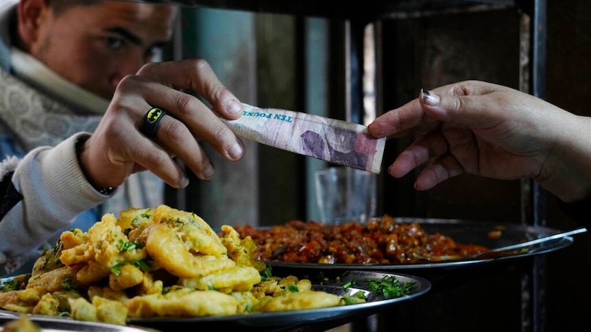 A man buys food at a restaurant in Cairo, Egypt.