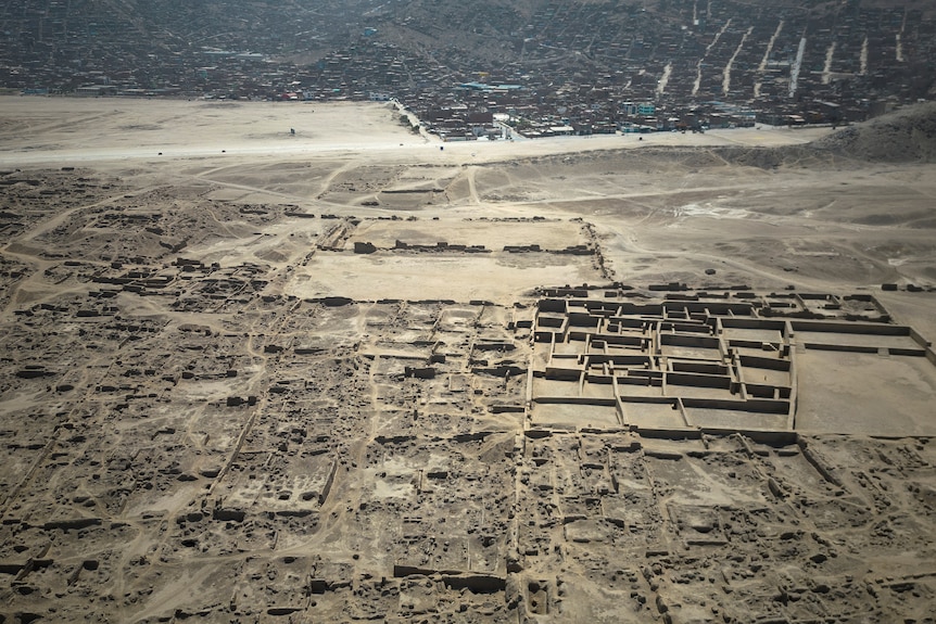 Aerial view of archaeological complex of Cajamarquilla near township.