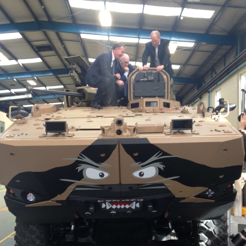Tasmanian Premier Will Hodgman (l) inspects the prototype defence vehicle built in Burnie June 29, 2016