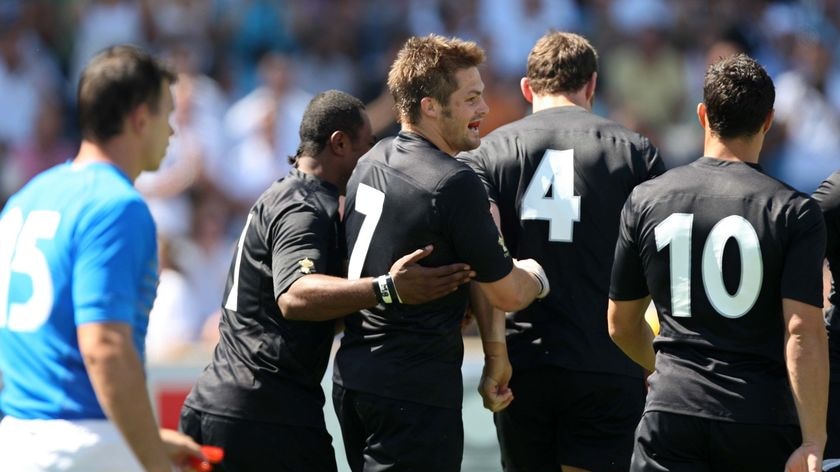 Black-out ... Richie McCaw is congratulated after scoring for New Zealand