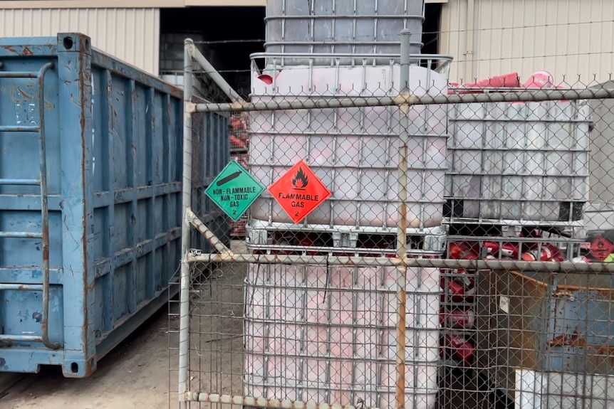 A pic of plastic containers in an industrial yard.