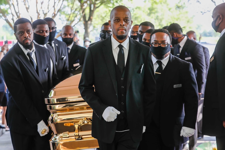 Pallbearers bring the coffin into The Fountain of Praise church in Houston for the funeral for George Floyd.