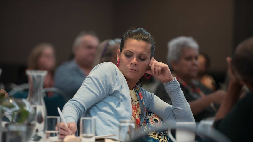 Woman listens at First Nations Regional Dialogue in Brisbane