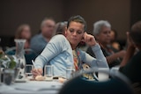 Woman listens at First Nations Regional Dialogue in Brisbane