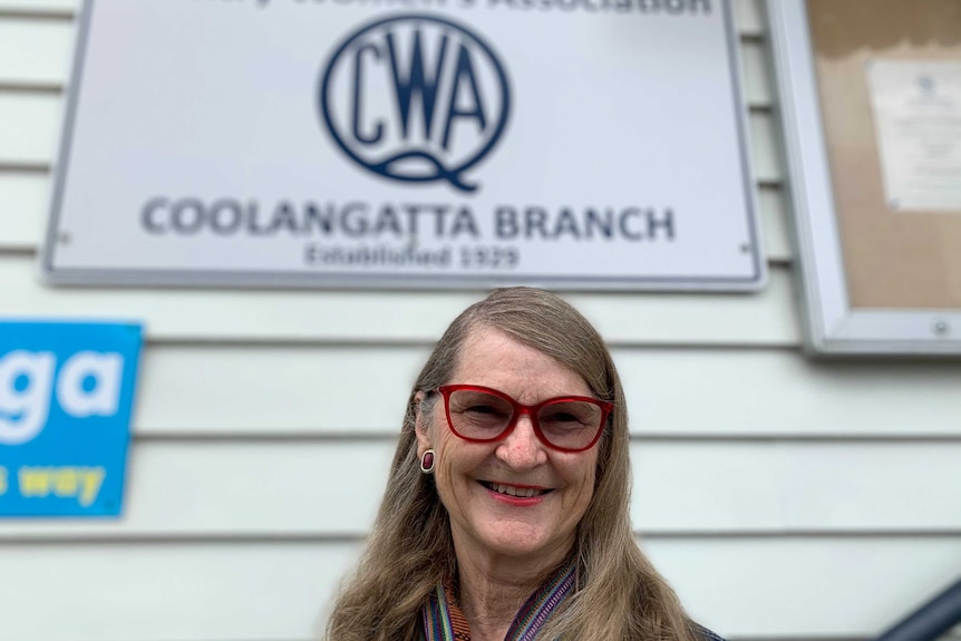 President of CWA poses for photo at front entrance of Coolangatta branch