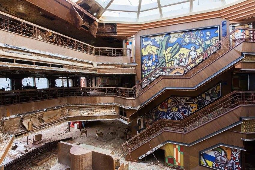 Damaged atrium area with debris strewn averywhere.