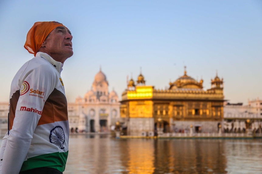 Pat Farmer across the water from the Golden Temple at dusk.