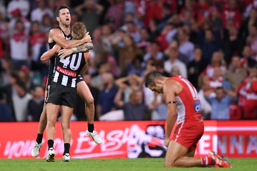Jeremy Howe and Josh Smith embrace after Collingwood held on to beat Sydney at the SCG.