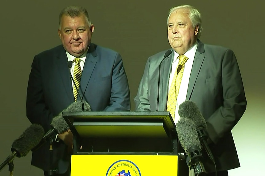 Craig Kelly and Clive Palmer talking to reporters