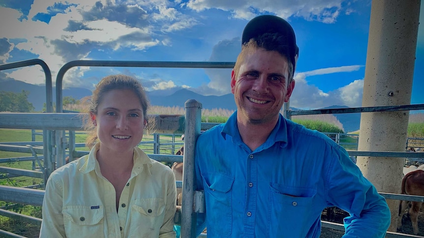 A husband-and-wife team stand together after a hard day of drafting cattle at the yards