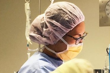 A young female surgeon in an operating theatre.